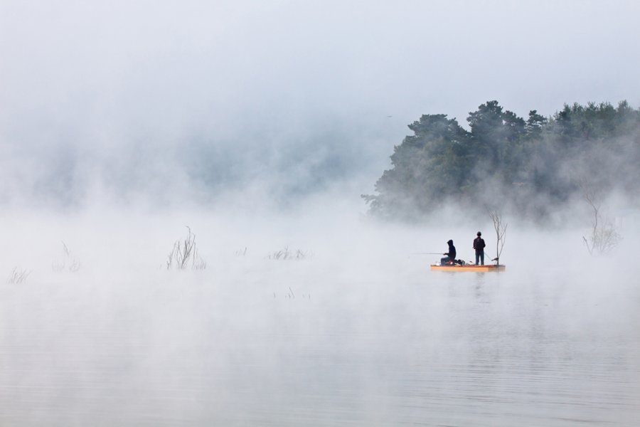 FISHING ON THE CLOUD: Anglers fishing in the mist rising from the reservoir by dawn look like fishing on cloud. Gosam reservoir, Anseong, Gyeonggi-do, Korea.