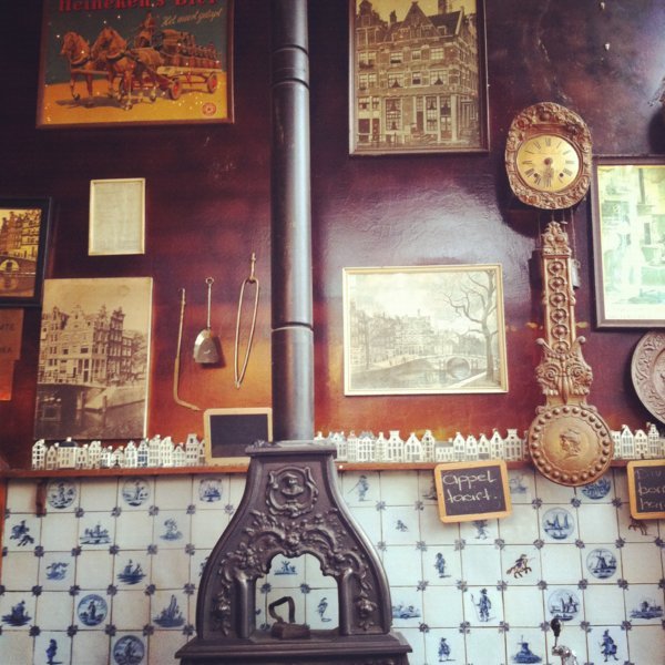 Superbe poêle en fonte et carreaux de Delft au Papeneiland Cafe, une maison avec façade à pignons datant de 1642, Quartier du Jordaan - Amsterdam, Pays-Bas